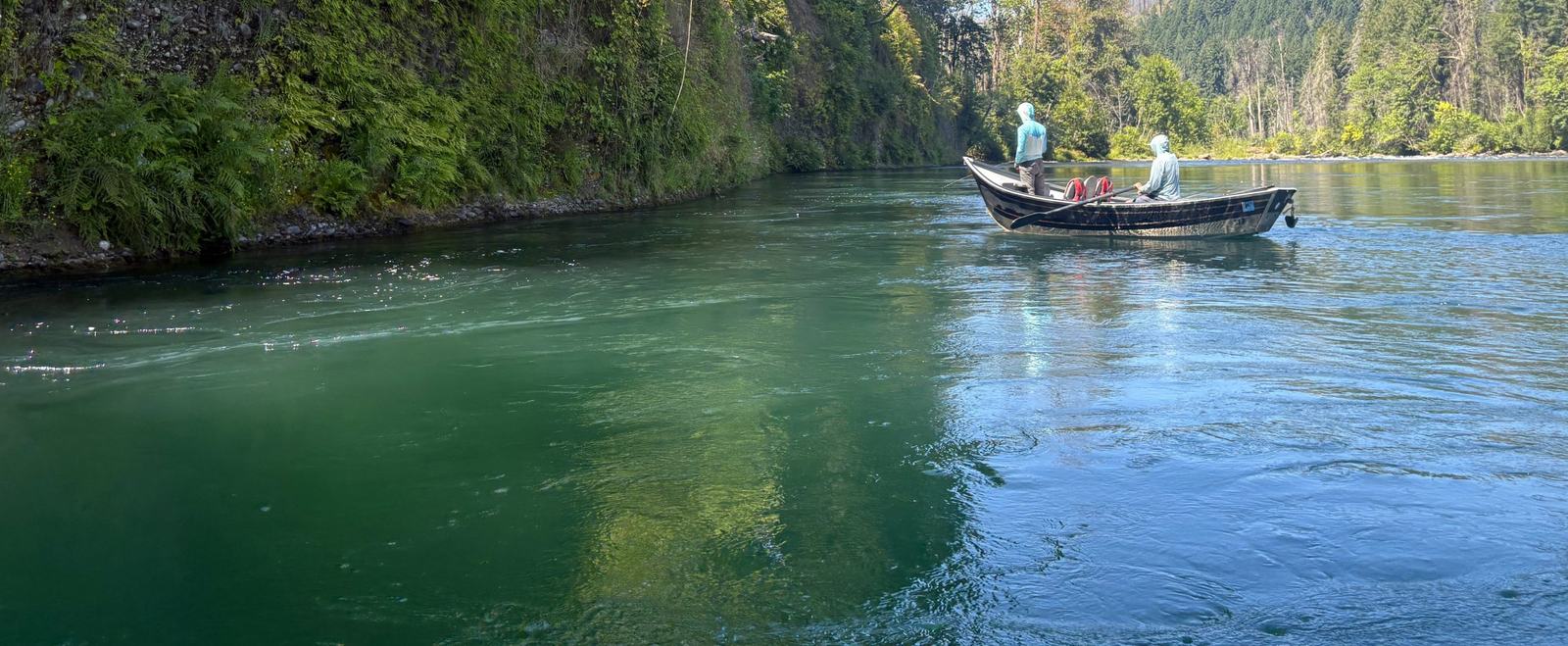 Two Dudes drift boat on the turquoise water of the McKenzie River