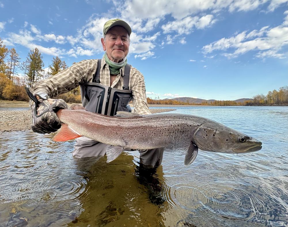 Angler holding a Mongolian taimen