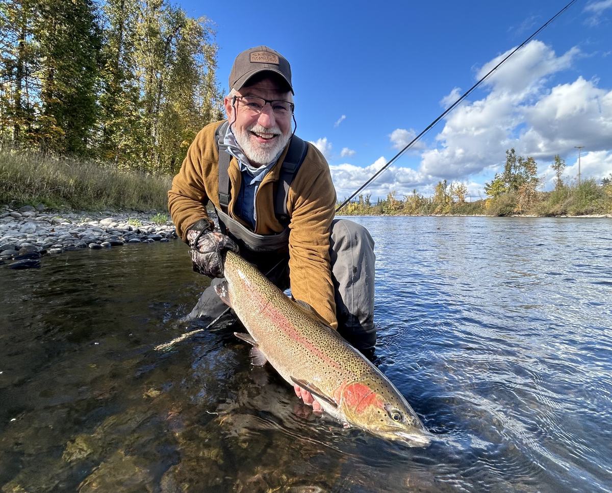 Angler holding a wild Oregon steelhead