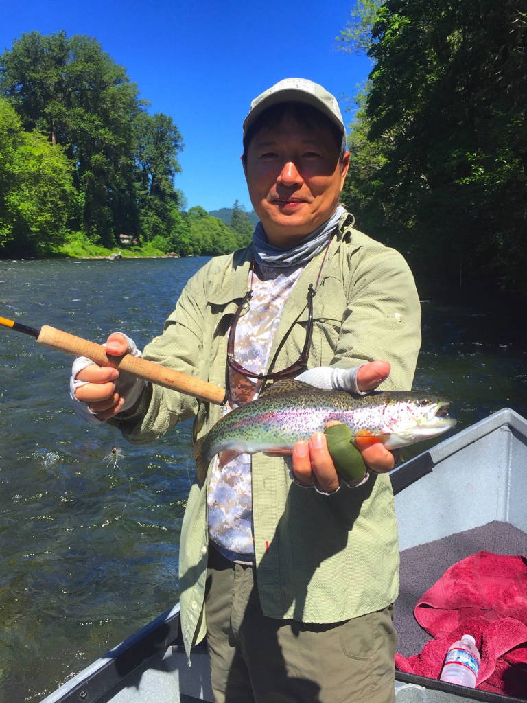 Angler aboard a drift boat on the McKenzie River